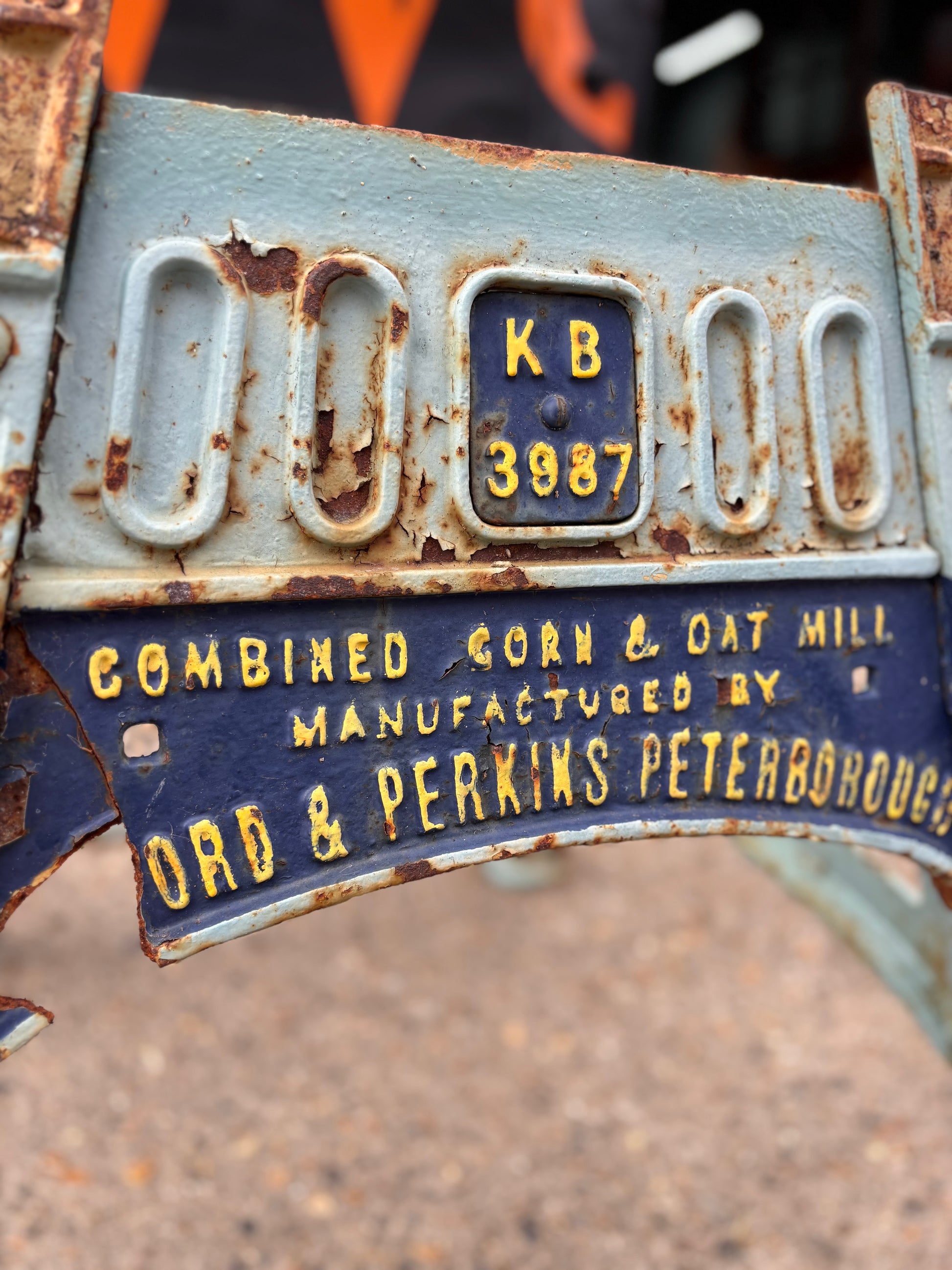 Rust-covered metal machine base with text and a on a blurred background