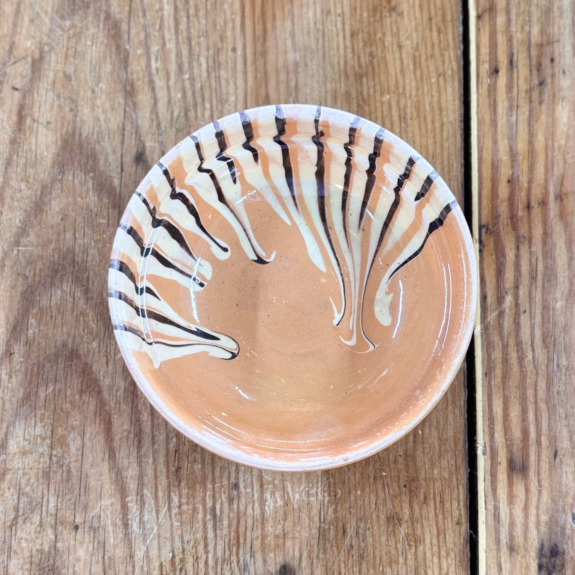 Ceramic bowl with decorative patterns on a wooden surface