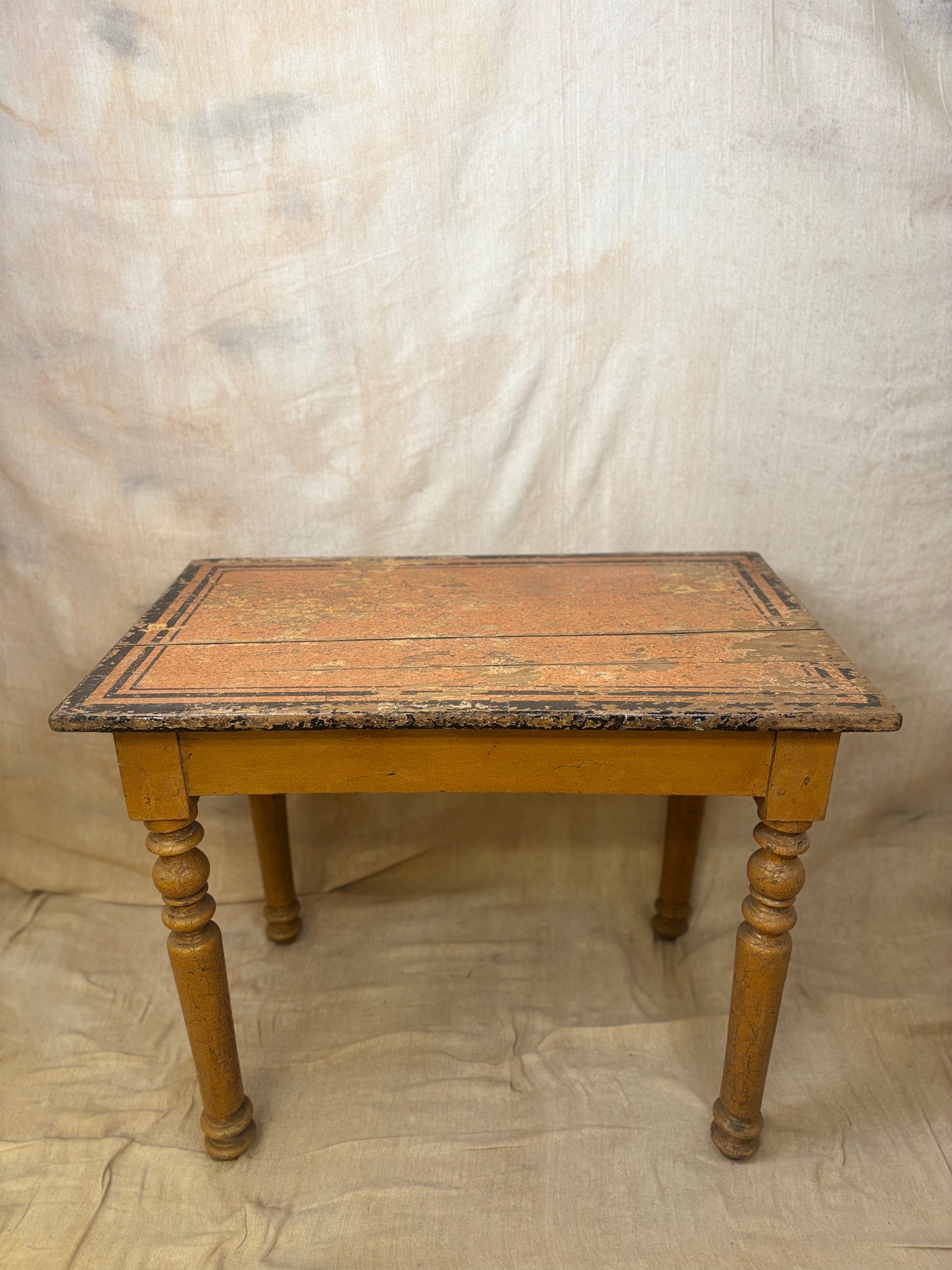 Vintage wooden table with a worn surface on a plain background