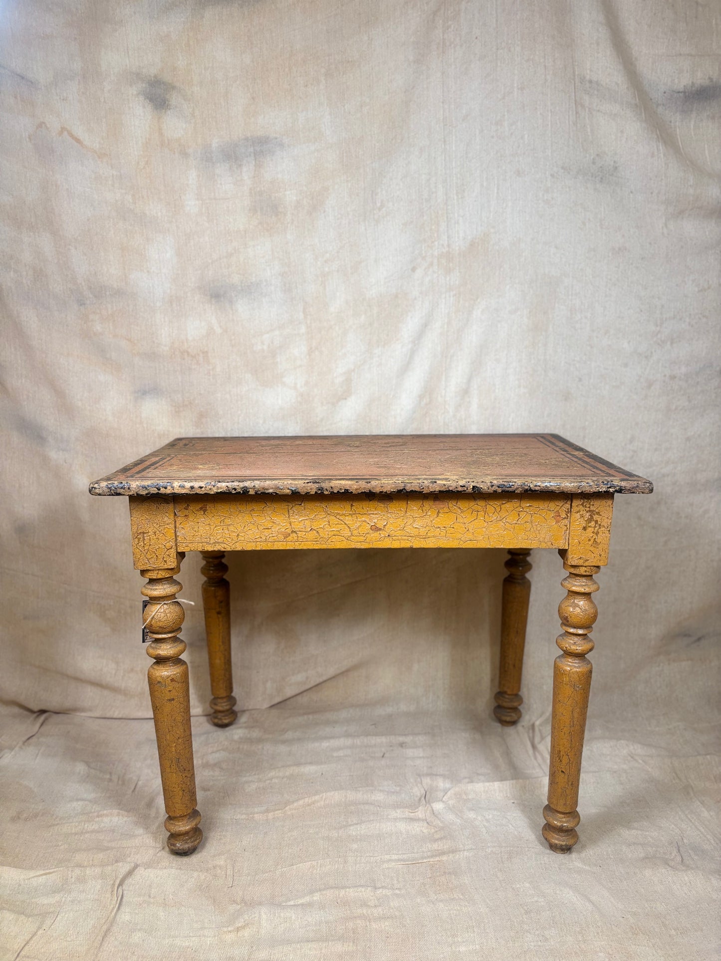 Wooden table with decorative carvings on a plain background