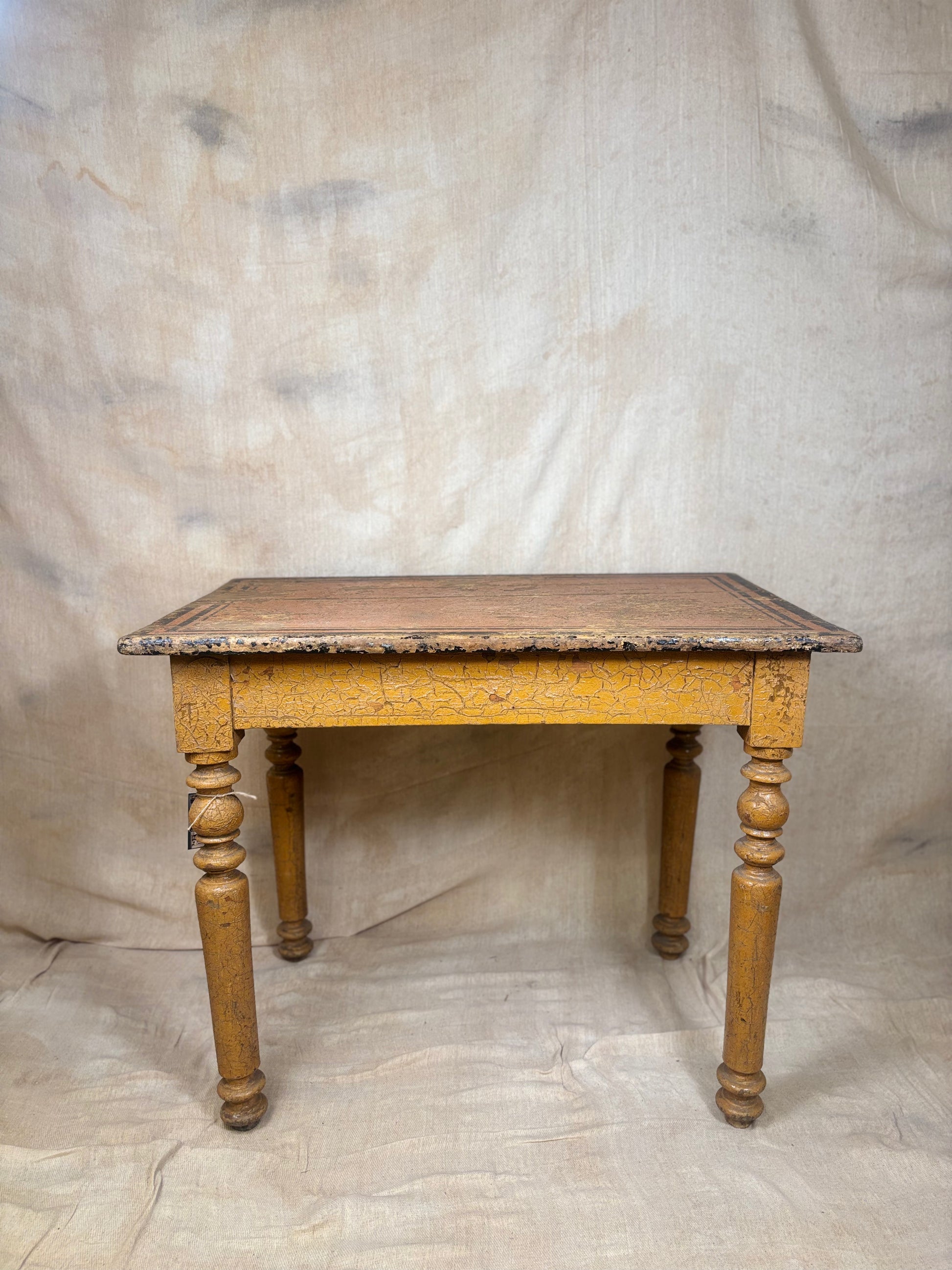 Wooden table with decorative carvings on a plain background