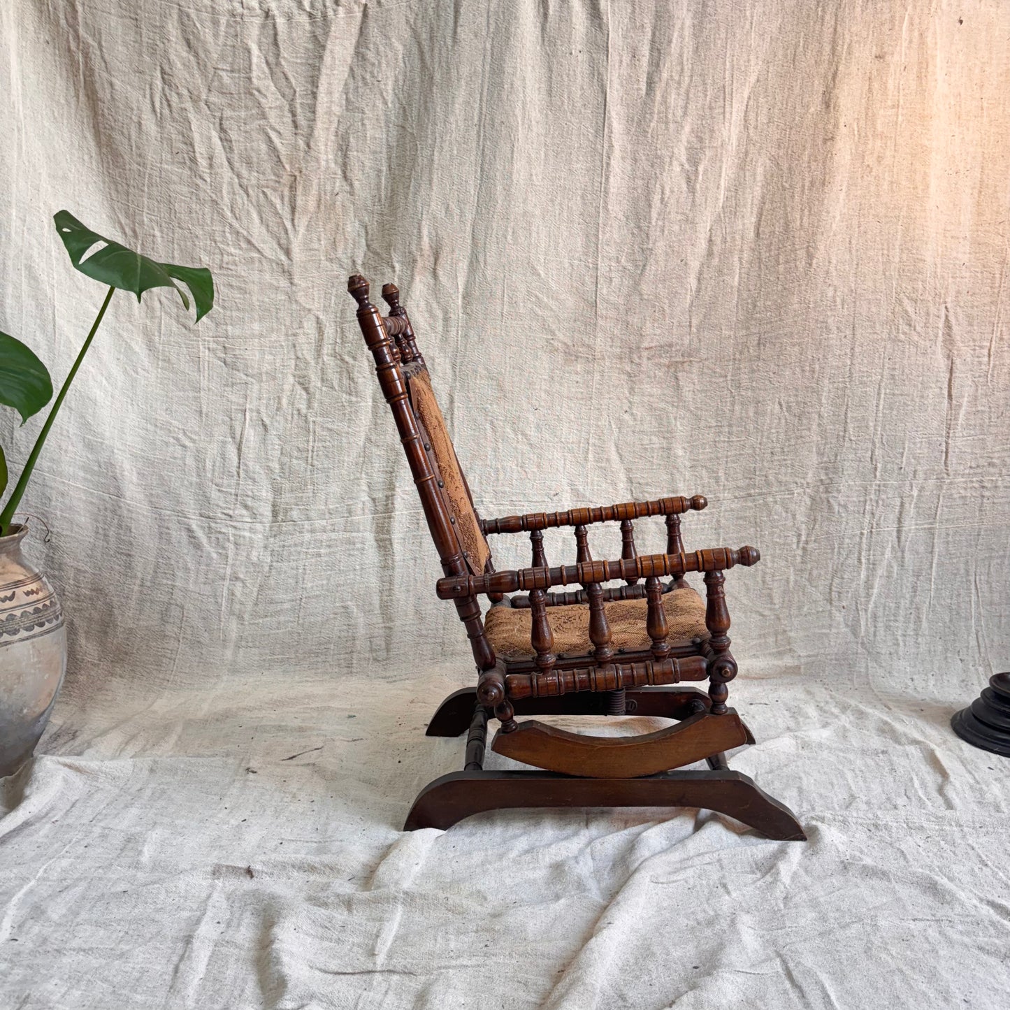 Wooden rocking chair on a textured white background