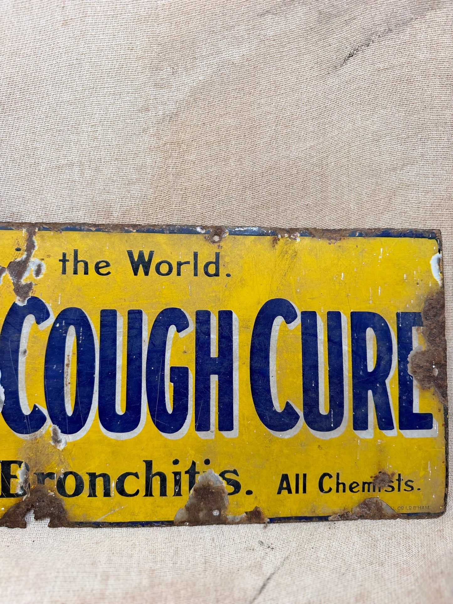 Vintage sign for Veno's Lightning Cough and Cold remedy on a textured beige background