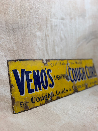 Vintage sign for Veno's Lightning Cough and Cold remedy on a textured beige background