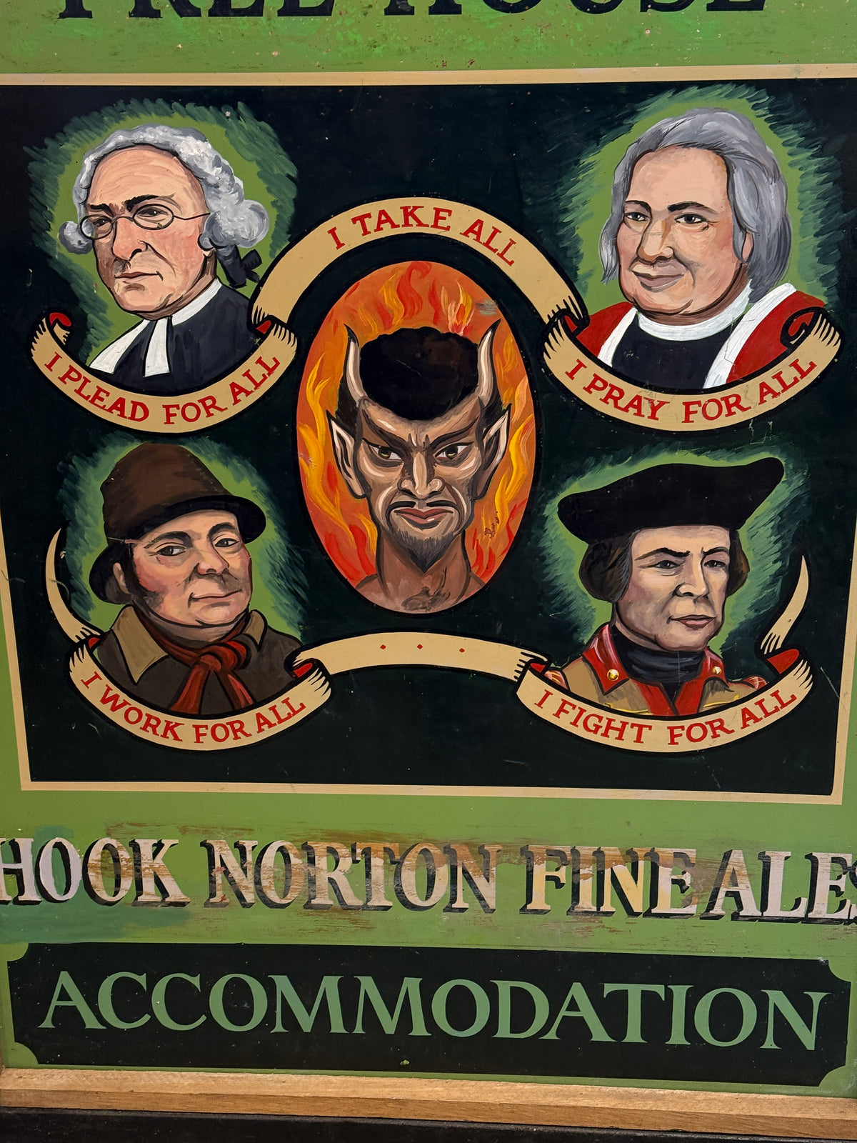 A vintage illustrated sign or poster with four historical portraits around a central devil-like face, with banners reading phrases such as 'I LEAD FOR ALL,' 'I PRAY FOR ALL,' 'I WORK FOR ALL,' and 'I FIGHT FOR ALL.' Large text at the bottom reads 'HOOK NORTON FINEALE' and 'ACCOMMODATION.