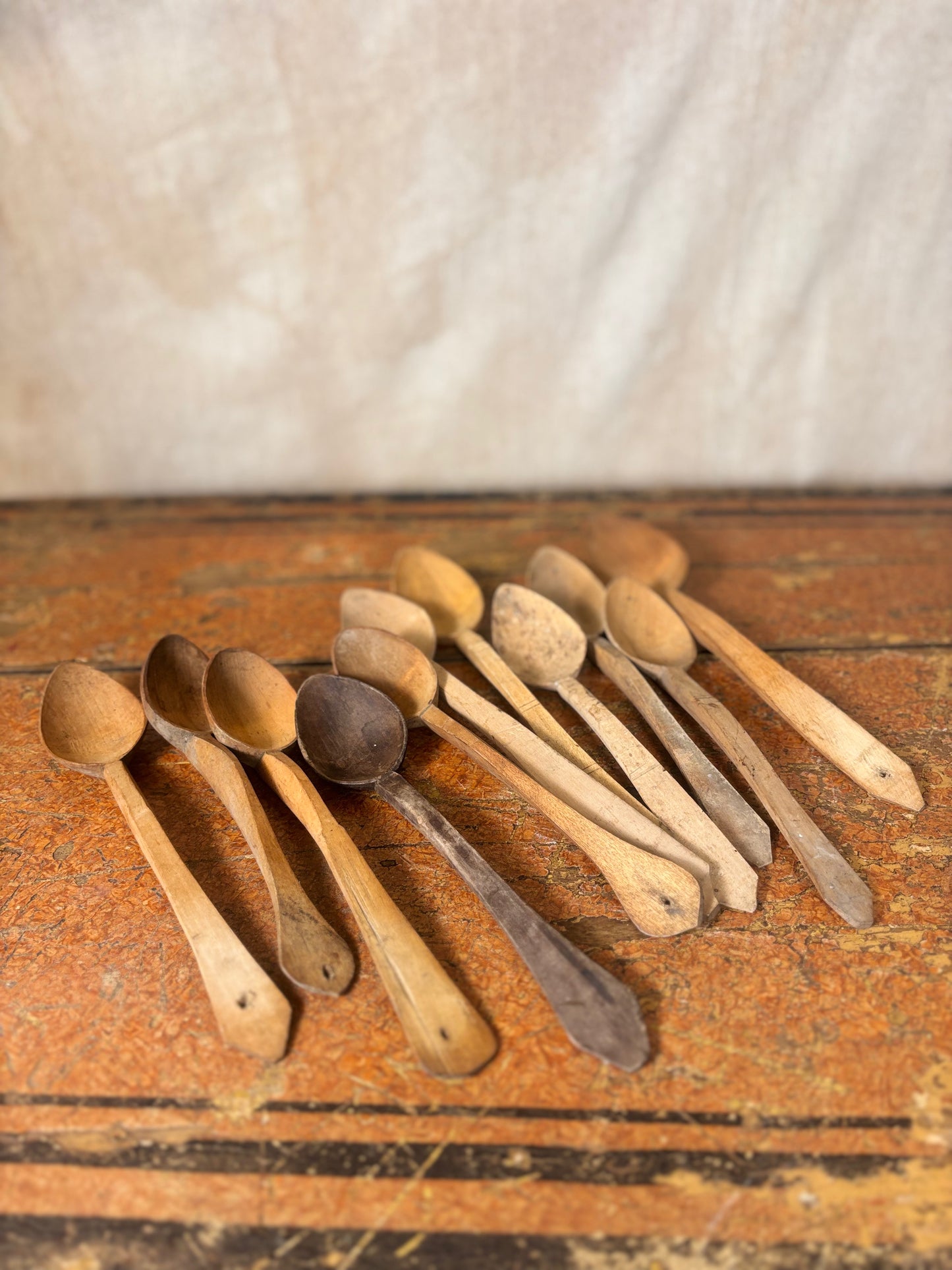 Set of wooden spoons on a rustic wooden surface with a neutral background